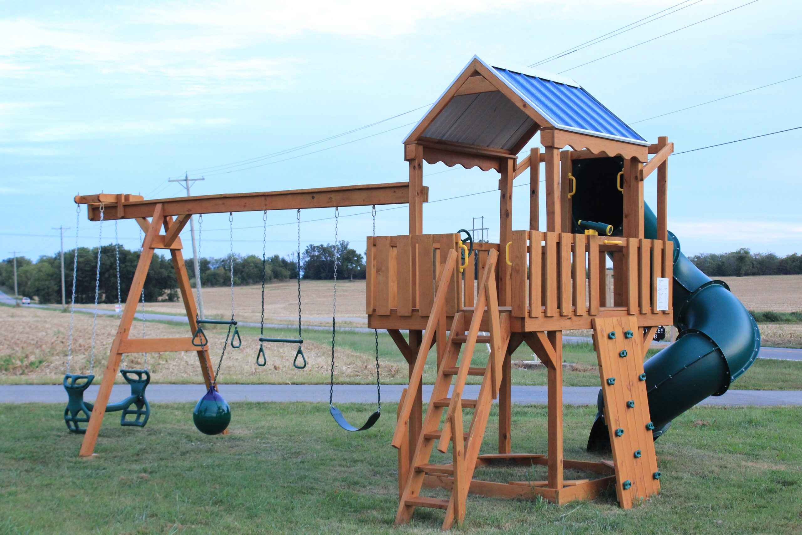 A single level deck elevated on sturdy stilts with a peaked roof for maximum headroom. The high vantage point creates an exciting play experience while providing shade. Perfect for smaller yards where you want to maximize ground space beneath for additional activities.