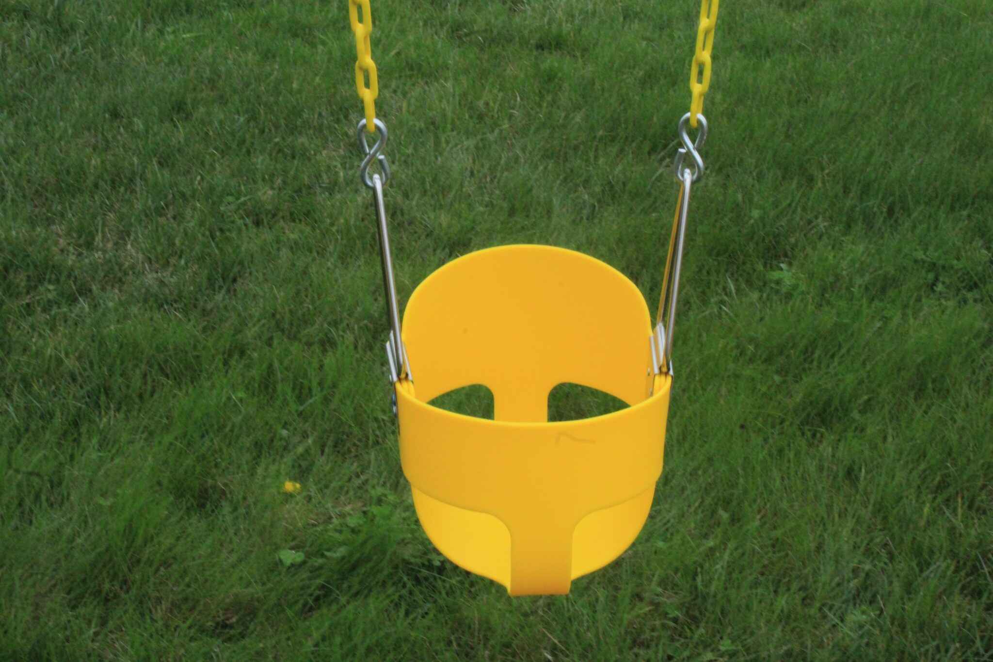 Specially designed for young children, this swing has a high-back seat with a three-point safety harness. The soft, weather-resistant plastic construction and coated chains ensure safe, comfortable swinging.